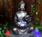 Tranquil sitting Buddha with bowl water feature fountain Slight Left angle view