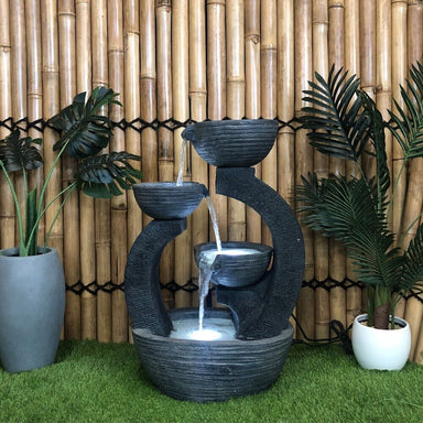 Triple Plate Bowls Cascade Water Feature Fountain background with plants