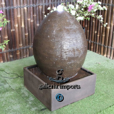egg shaped water fountain rust right angle view