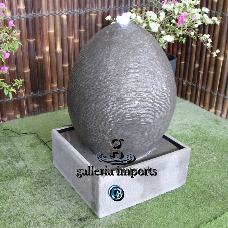 outdoor egg fountain with plant